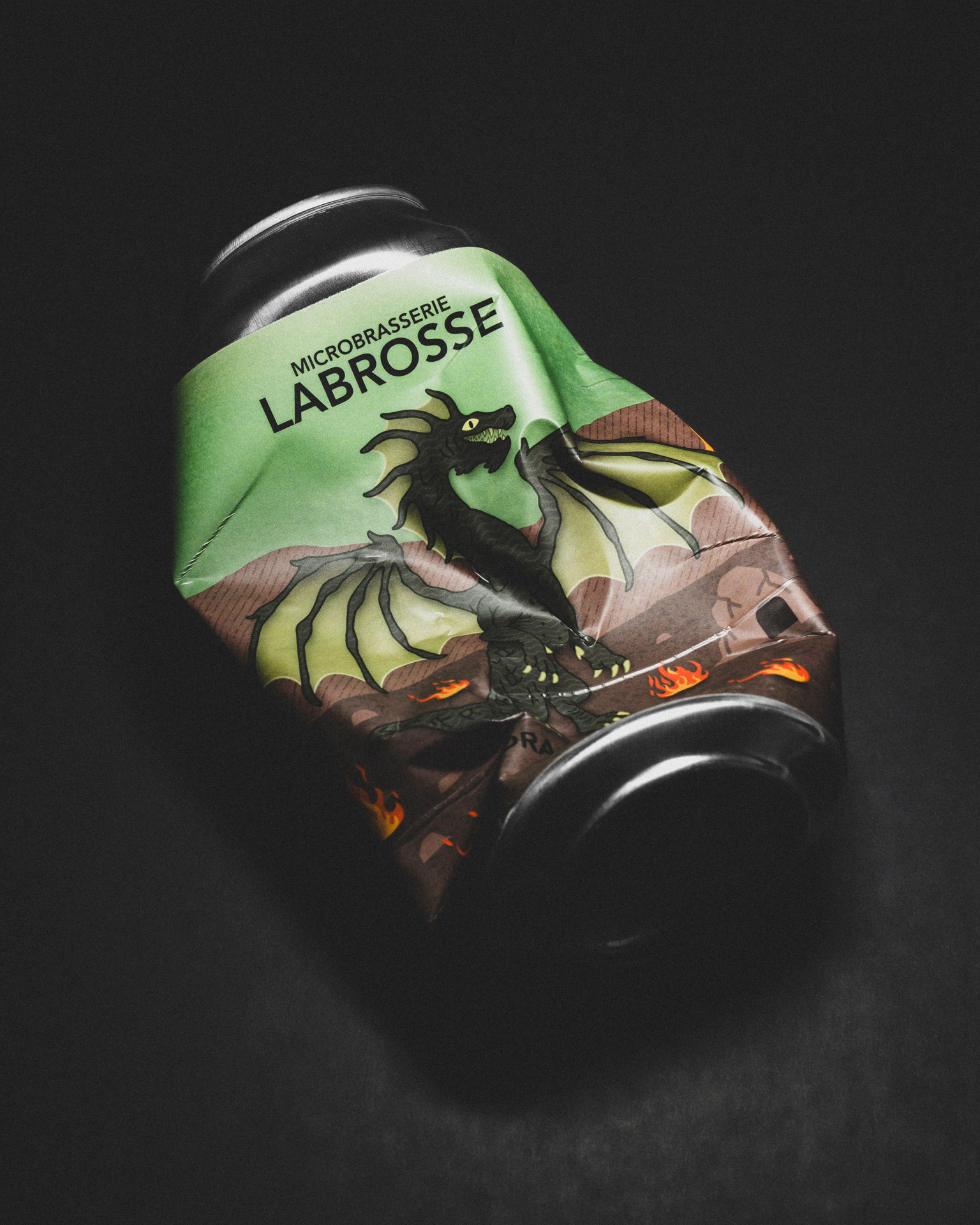Crushed can of Labrosse Brewery's Dragon Sap, set against a high-contrast black backdrop.